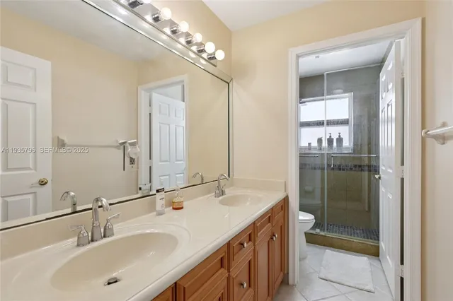 a bathroom with a sink double vanity and a mirror