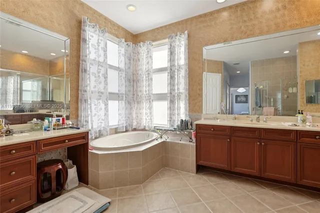 a large swimming pool with a large window and double vanity