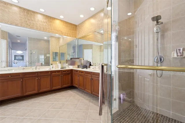 a large bathroom with a granite countertop sink a toilet a mirror and shower