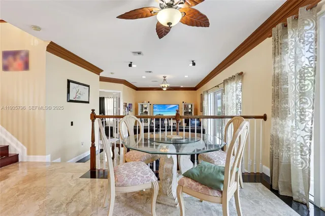 a view of a dining room with furniture wooden floor and chandelier