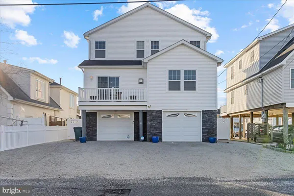 a front view of a house with a garage and a yard