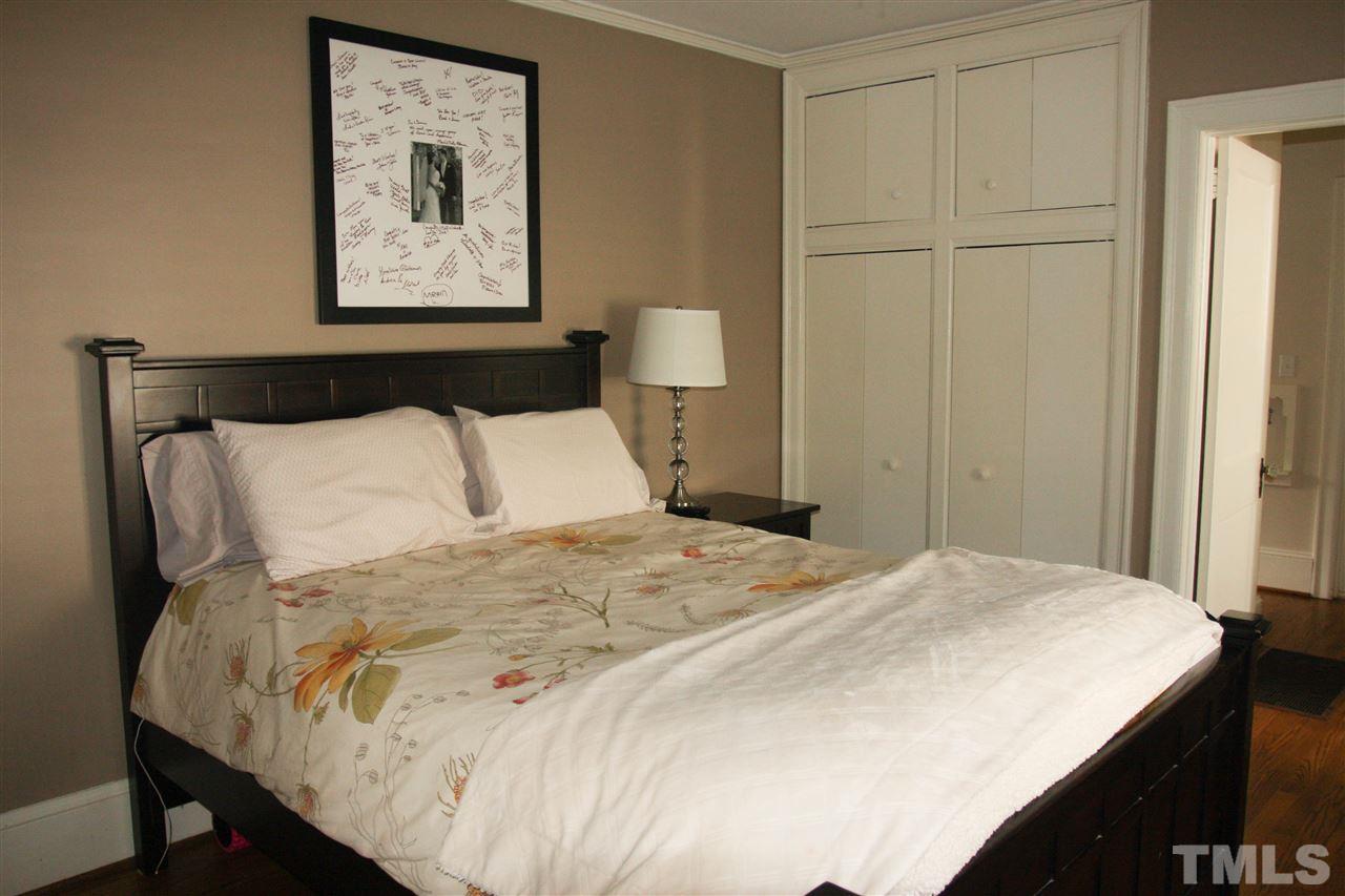 726 Kimbrough Street Raleigh, NC 27608 - Photo 11 of 18 a bedroom with a bed and a painting on the wall