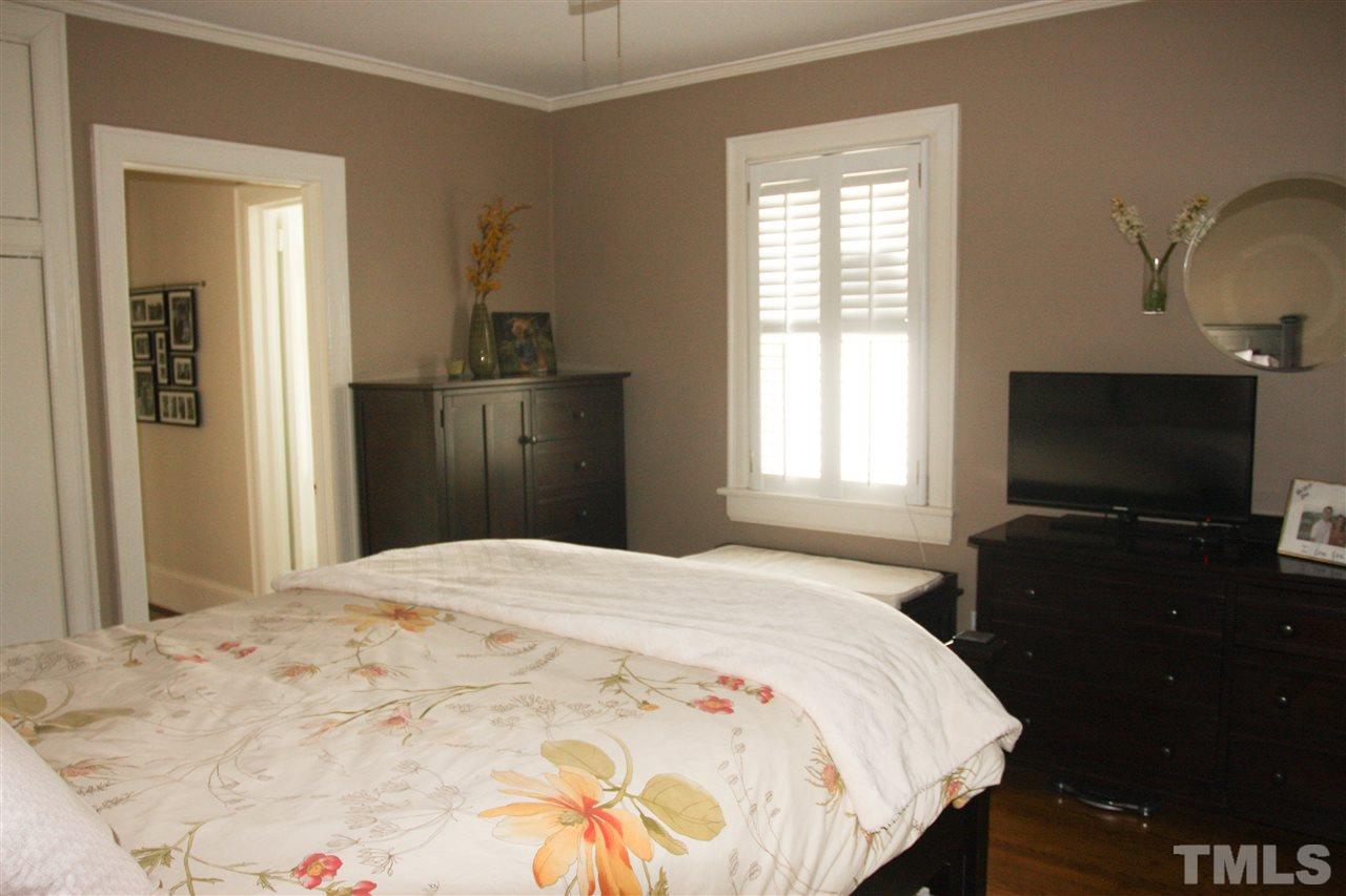 726 Kimbrough Street Raleigh, NC 27608 - Photo 12 of 18 a bedroom with a bed and a flat screen tv