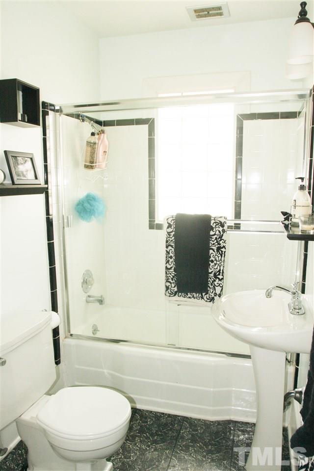 726 Kimbrough Street Raleigh, NC 27608 - Photo 13 of 18 a bathroom with a sink toilet and shower
