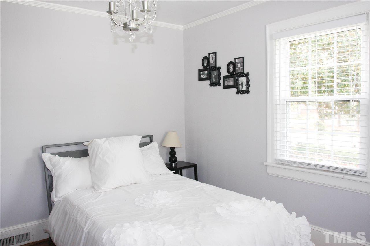 726 Kimbrough Street Raleigh, NC 27608 - Photo 15 of 18 a large bed in a bedroom next to a window