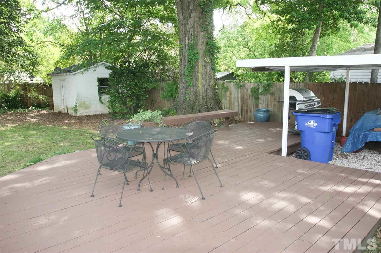726 Kimbrough Street Raleigh, NC 27608 - Photo 16 of 18 a view of a patio with a table chairs and a backyard