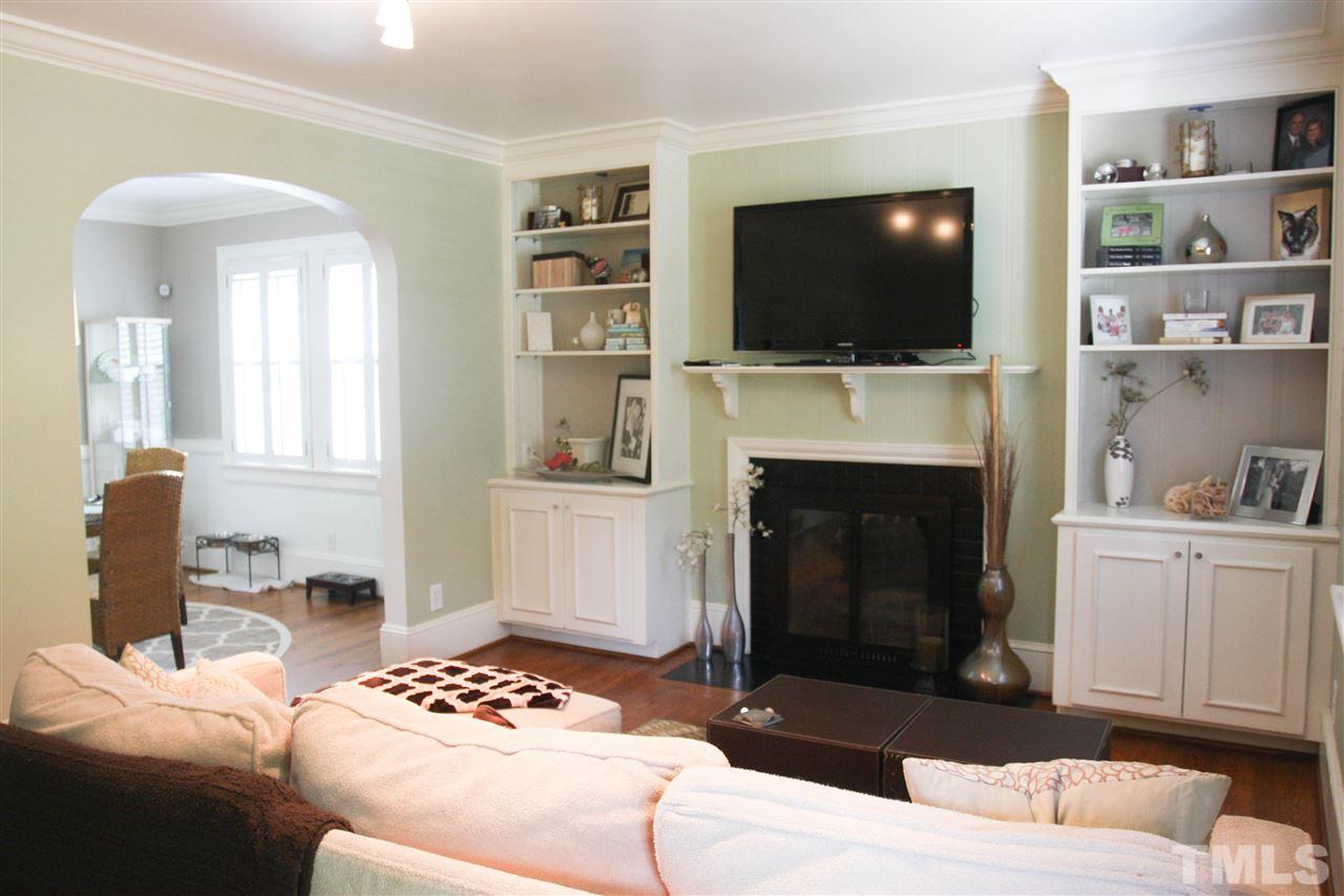 726 Kimbrough Street Raleigh, NC 27608 - Photo 3 of 18 a living room with furniture a flat screen tv and a fireplace