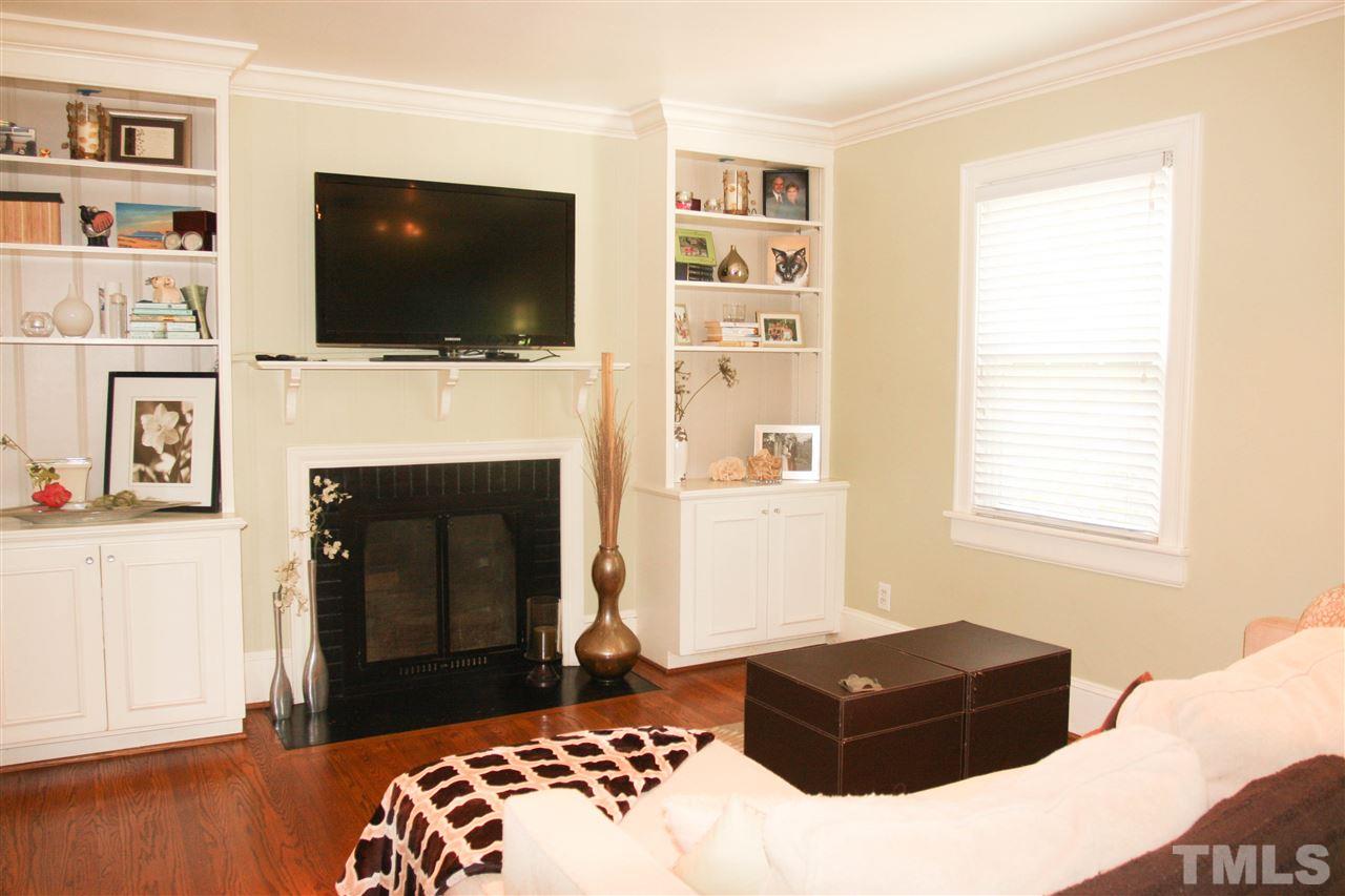 726 Kimbrough Street Raleigh, NC 27608 - Photo 4 of 18 a living room with a flat screen tv and a fireplace
