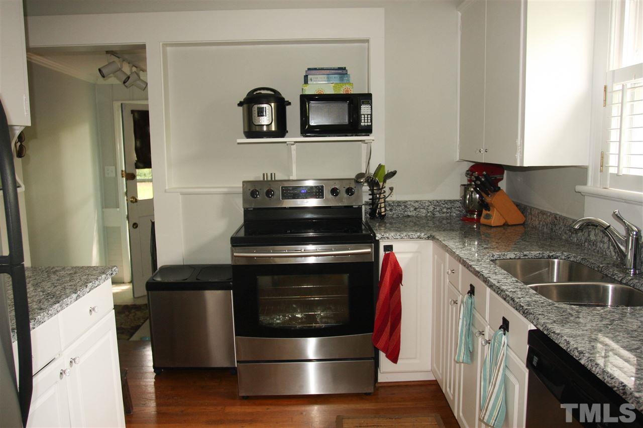 726 Kimbrough Street Raleigh, NC 27608 - Photo 6 of 18 a kitchen with granite countertop stainless steel appliances and wooden cabinets