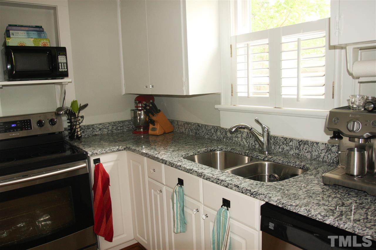 726 Kimbrough Street Raleigh, NC 27608 - Photo 7 of 18 a kitchen with a sink stove and microwave