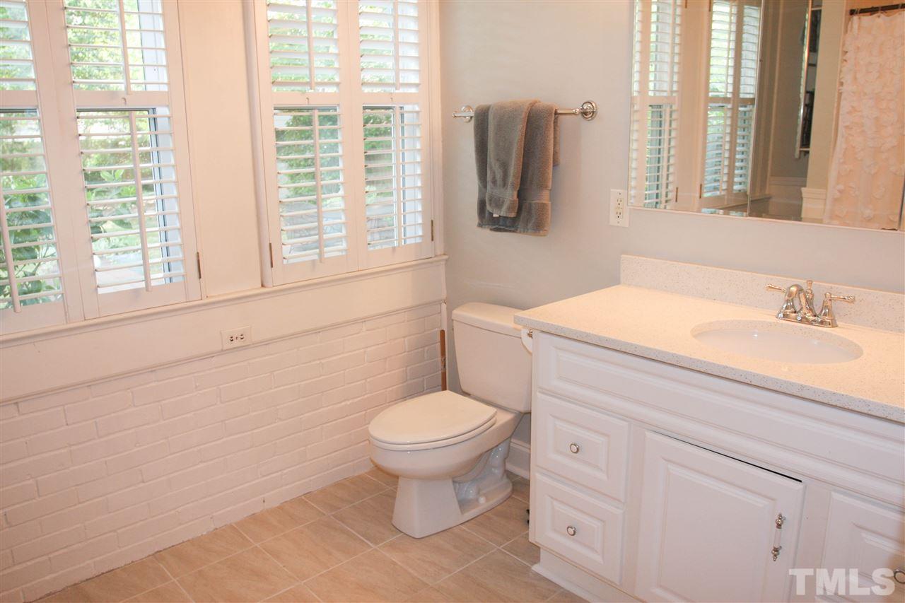 726 Kimbrough Street Raleigh, NC 27608 - Photo 10 of 18 a bathroom with a toilet sink and mirror