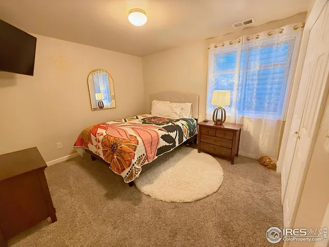 a bed room with a bed and a chair