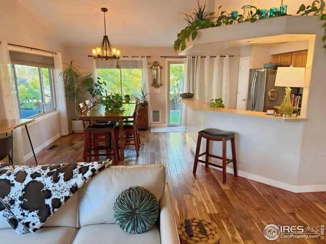 a view of a livingroom with furniture window and wooden floor