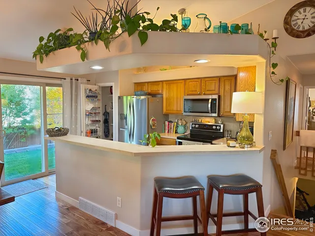 a kitchen with a table chairs refrigerator and cabinets