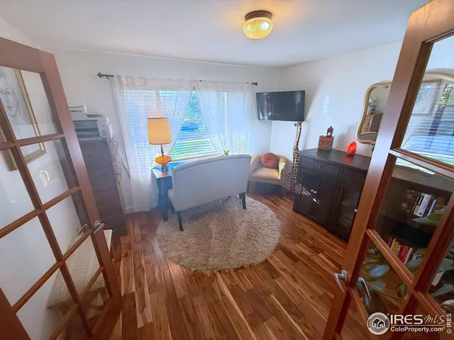 a workspace with furniture hardwood and a window