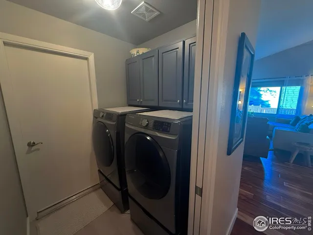 a view of a storage and utility room with a washer dryer