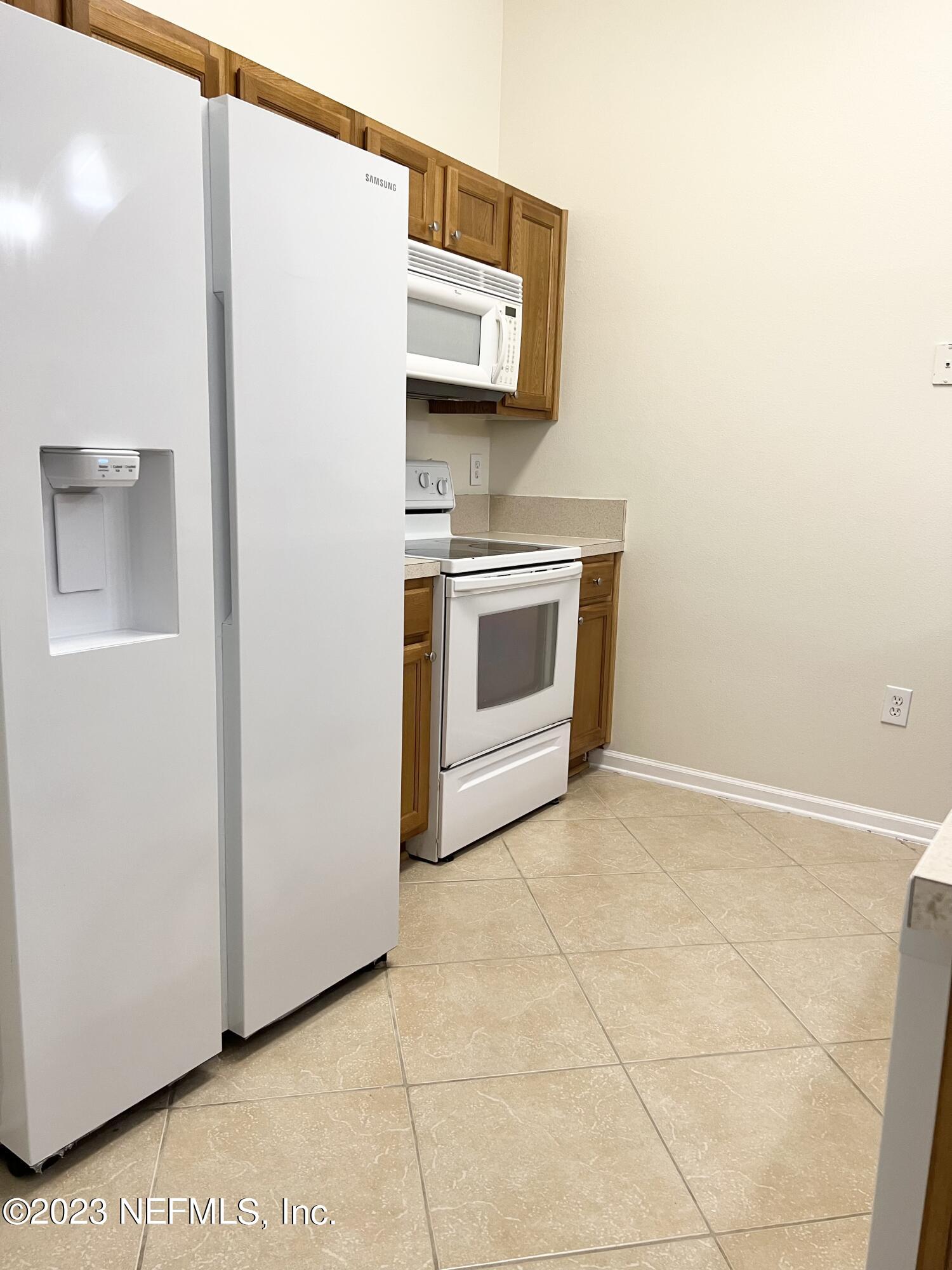 7920 Merrill Road, Unit 803 Jacksonville, FL 32277 - Photo 5 of 12 a view of a storage and utility room with washer and dryer