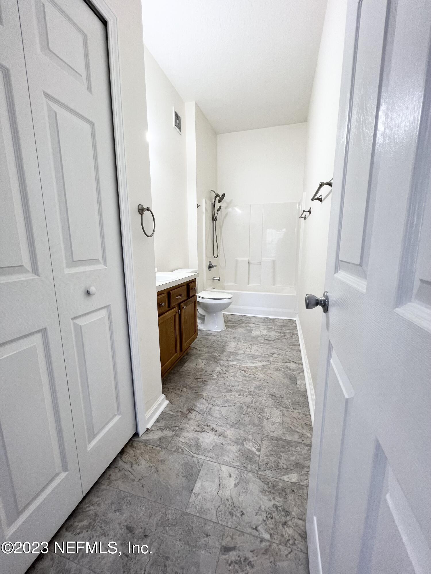 7920 Merrill Road, Unit 803 Jacksonville, FL 32277 - Photo 8 of 12 a bathroom with a sink a toilet and shower