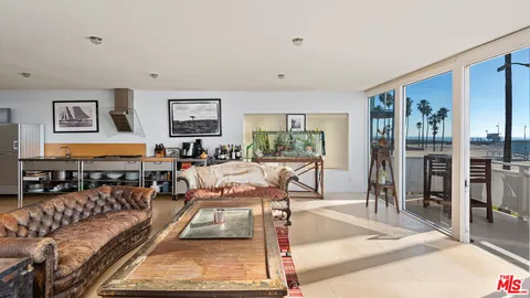 a living room with furniture a rug and a window
