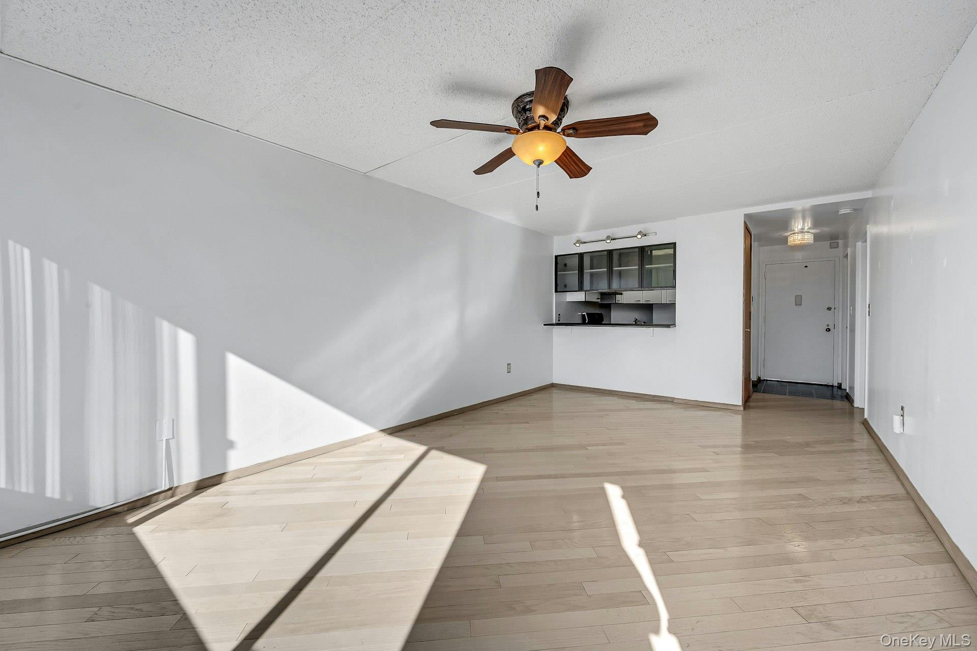 703 Pelham Road, Unit 412 New Rochelle, NY 10805 - Photo 14 of 26 Living Room angle showing breakfast bar and space for a dining table.