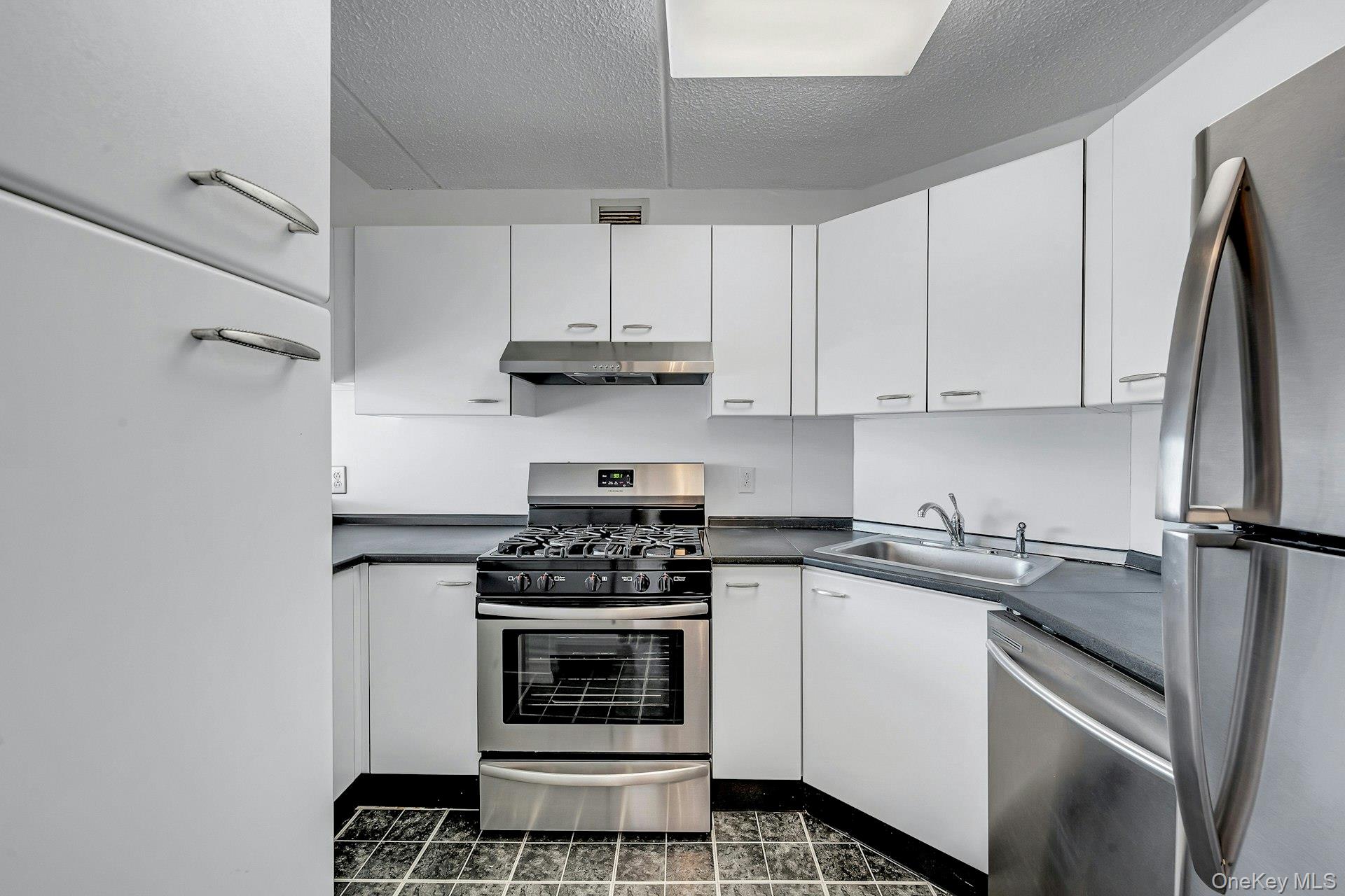 703 Pelham Road, Unit 412 New Rochelle, NY 10805 - Photo 9 of 26 Kitchen has lots of cabinets.