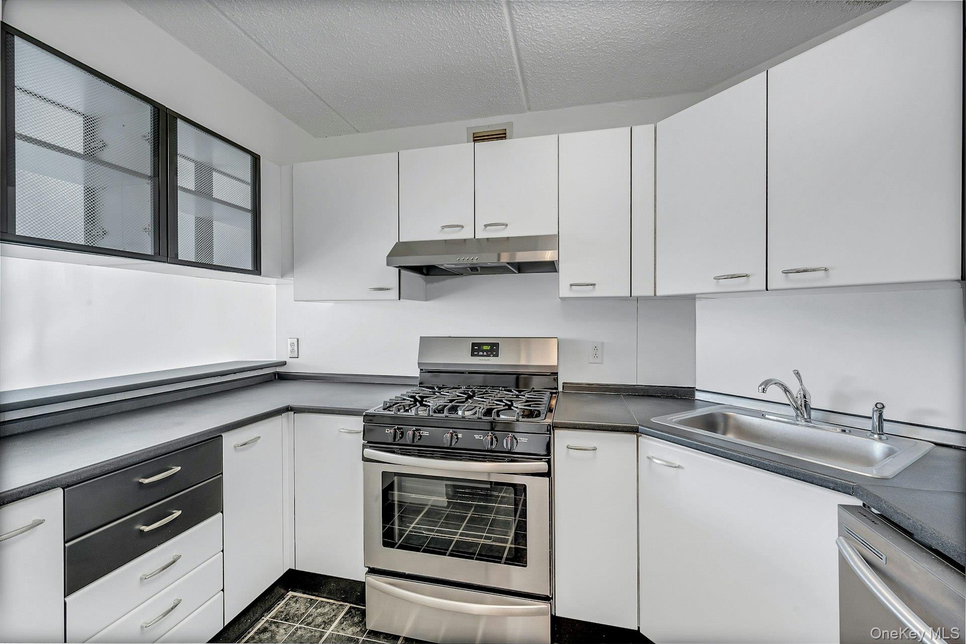 703 Pelham Road, Unit 412 New Rochelle, NY 10805 - Photo 10 of 26 Kitchen with stainless steel appliances.