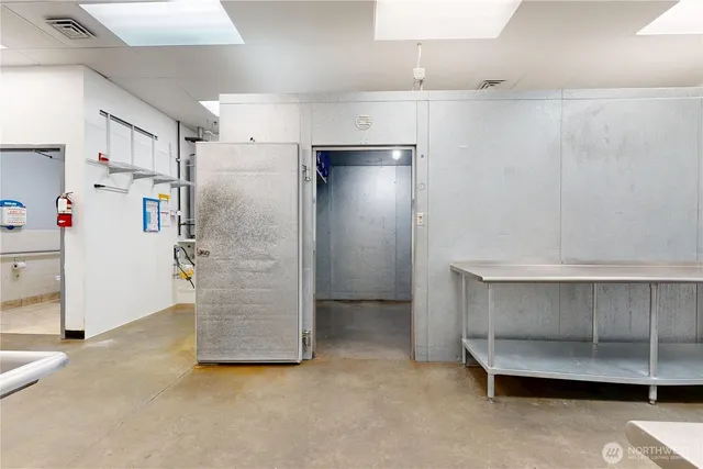 a view of an empty room with cabinet and stairs