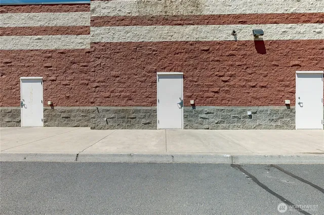 an aerial view of a house with a yard and ocean view