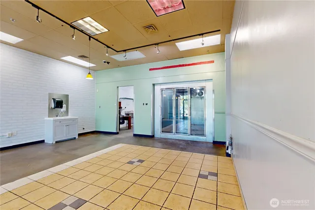 a view of a hallway with wooden floor and table