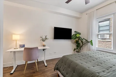 a bedroom with a bed and a chair