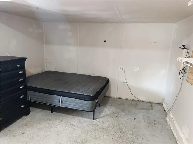 a bedroom with a bed and a table