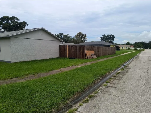 a view of a house with a yard and sitting area
