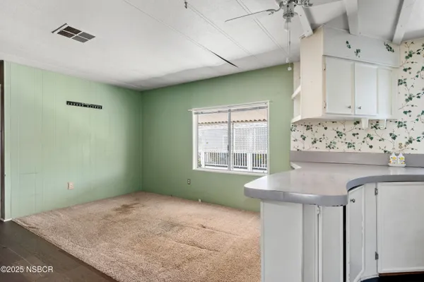 a kitchen with granite countertop a stove and cabinets