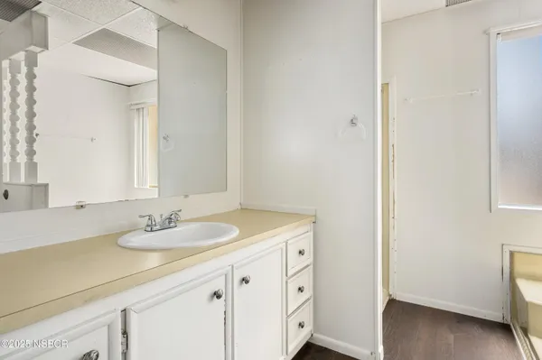 an empty room with windows and closet