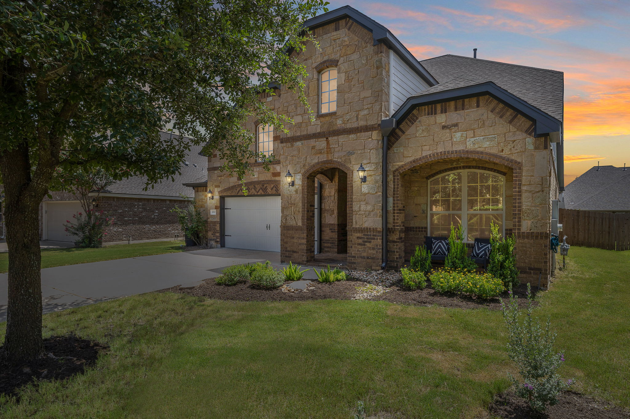 18913 Still Pond Road Pflugerville, TX 78660 - Photo 1 of 1 View of front of house with concrete driveway, stone siding, an attached garage, and a shingled roof