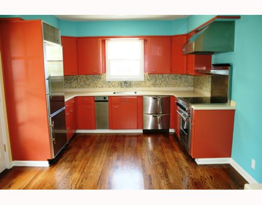 425 Peerman Place Corpus Christi, TX 78411 - Photo 4 of 10 a kitchen with stainless steel appliances granite countertop a refrigerator a sink dishwasher a stove and white countertops with wooden floor
