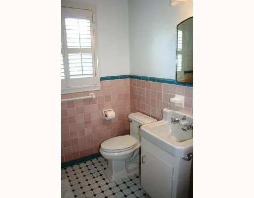 a bathroom with a sink a toilet and a window