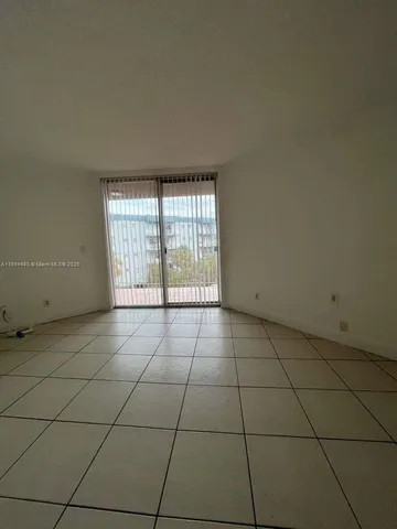 a view of an empty room and a window