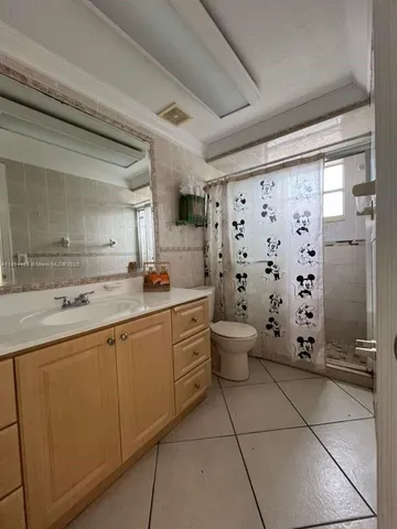 a spacious bathroom with a double vanity sink toilet and shower