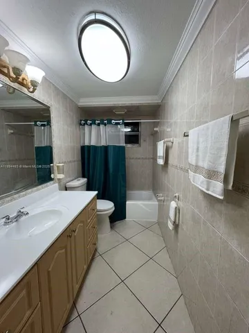 a bathroom with a double vanity sink mirror and toilet