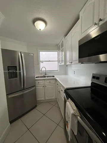 a kitchen with a sink stainless steel appliances and cabinets