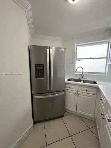 a kitchen with stainless steel appliances granite countertop a refrigerator sink and cabinets
