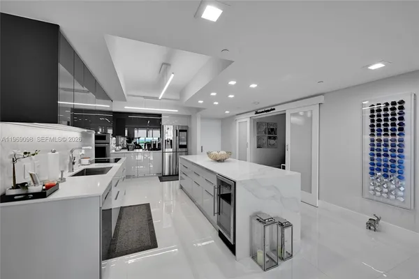 a large white kitchen with lots of counter top space