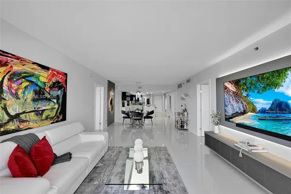 a living room with furniture and a floor to ceiling window