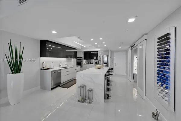 a kitchen with a refrigerator and a sink