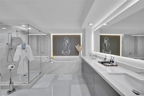 a bathroom with a granite countertop sink a shower and a mirror