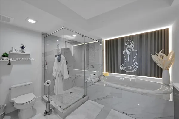 a bathroom with a shower and toilet