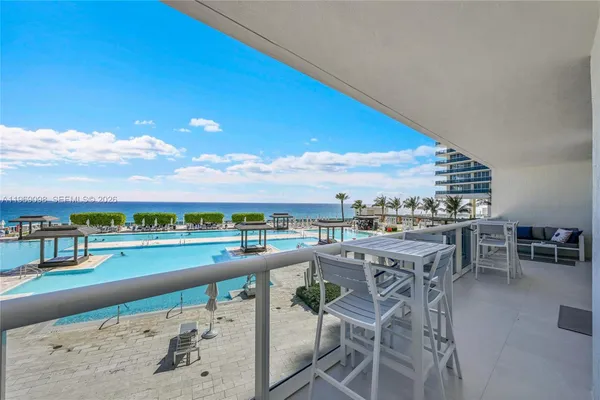 a view of a swimming pool with furniture
