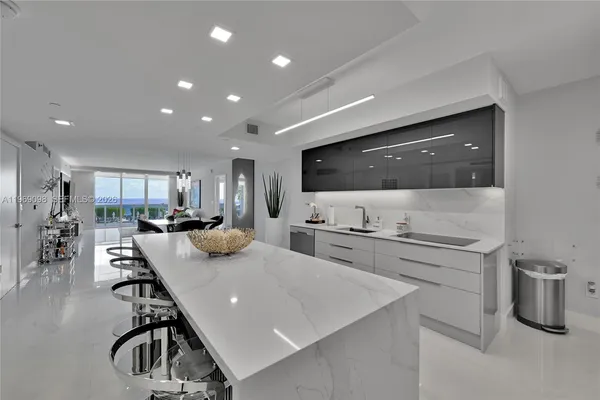a kitchen with sink refrigerator and microwave
