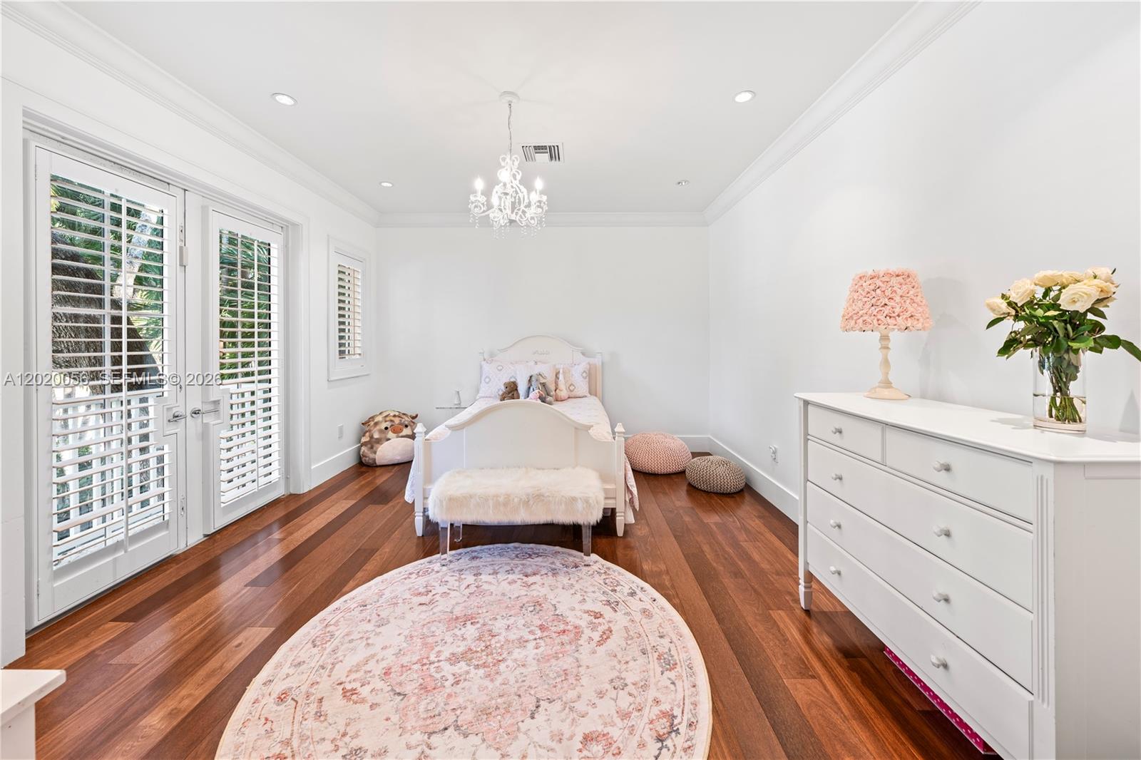 4196 Douglas Road Miami, FL 33133 - Photo 64 of 96 a bedroom with a bed and wooden floor